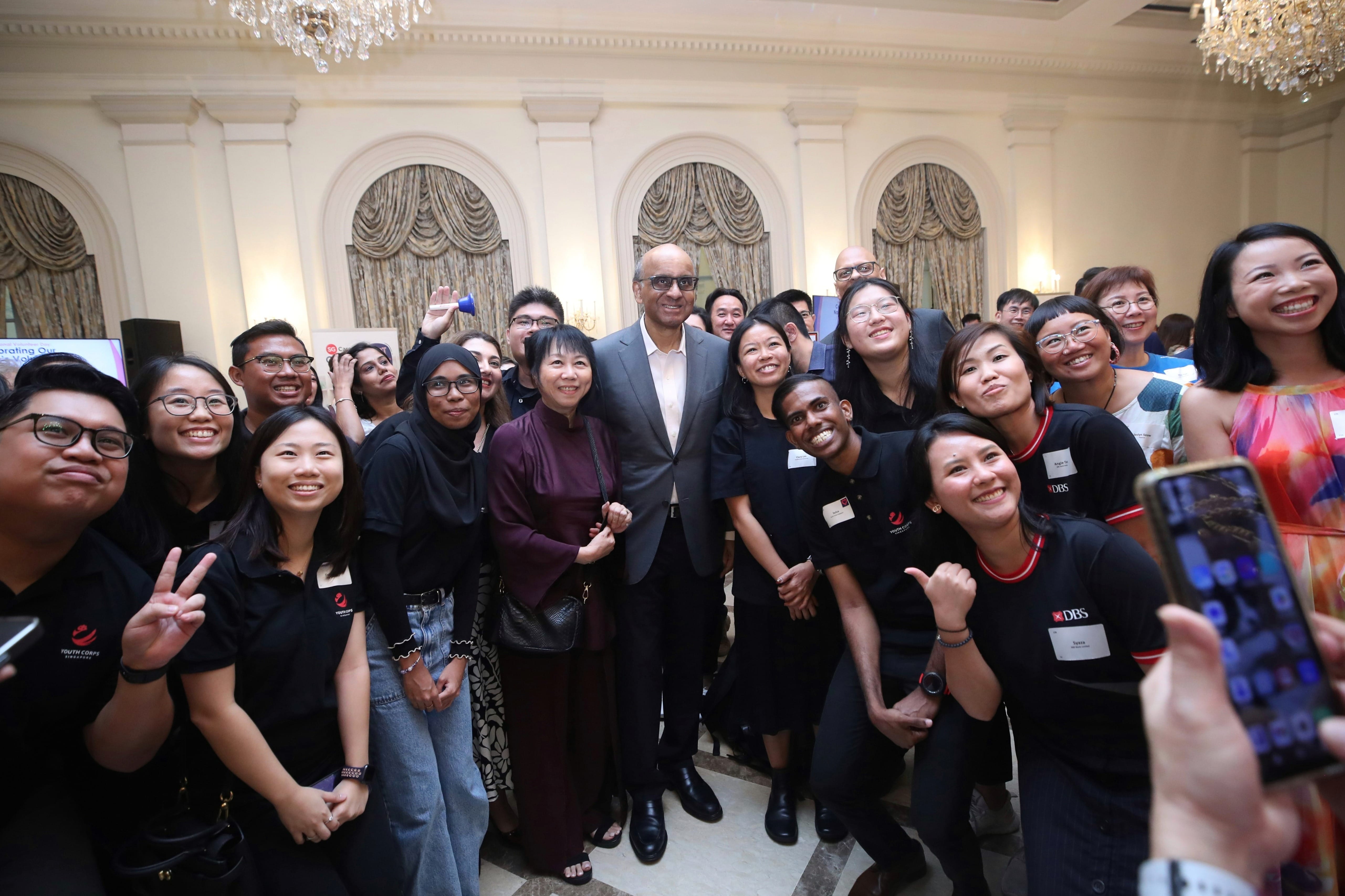 President Tharman posing with participants for a group photo.